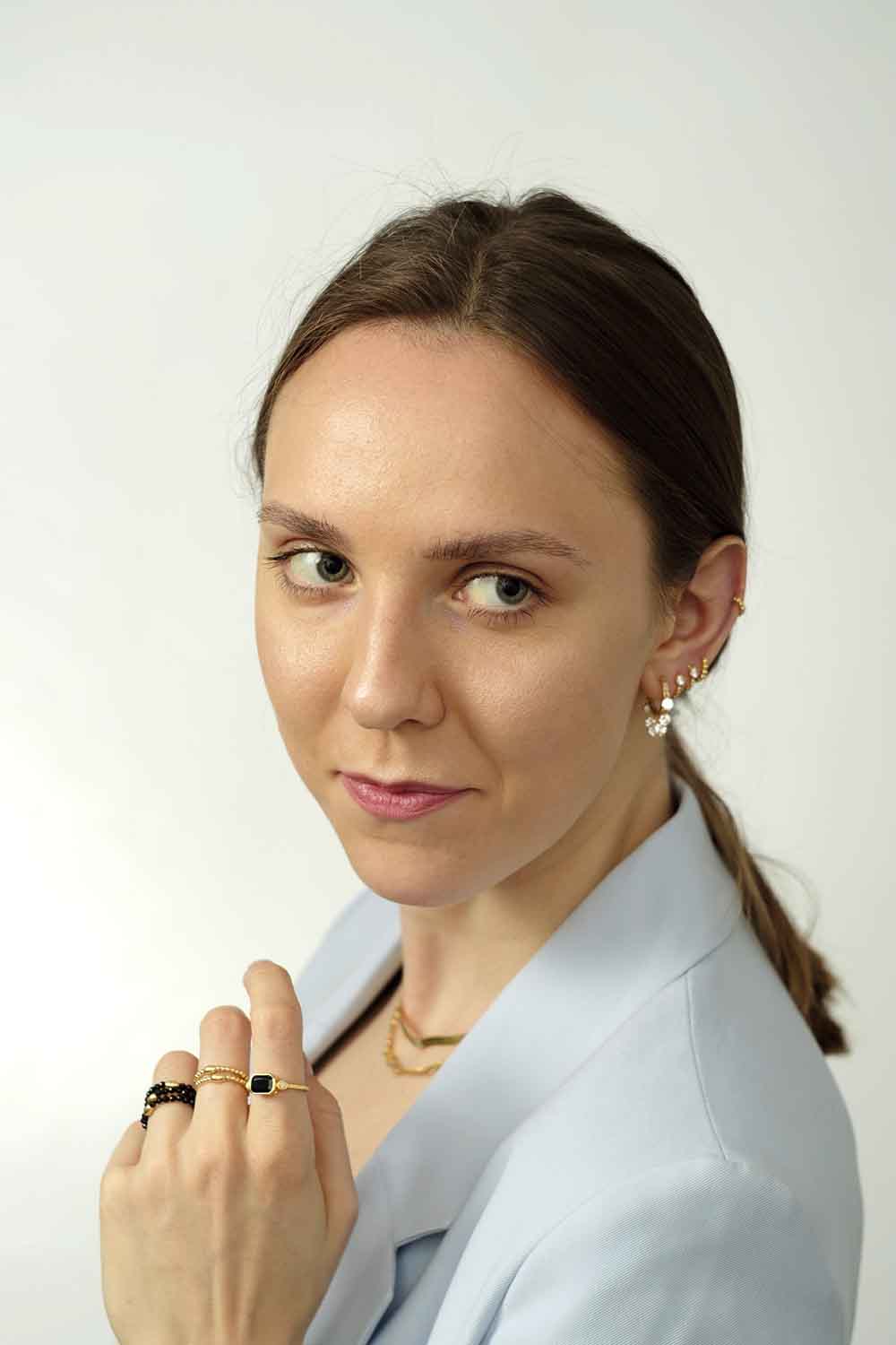 Ear piercings. Gold and silver earrings.